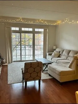 a living room with furniture and a floor to ceiling window