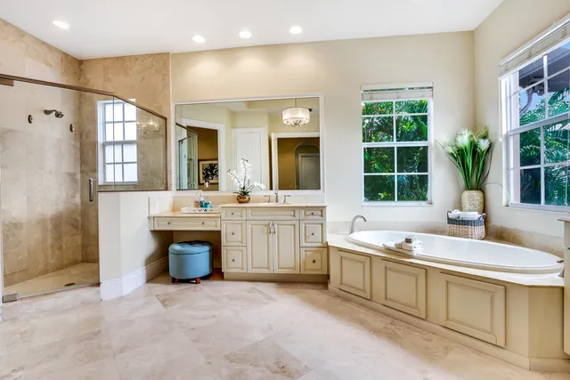 a bathroom with a sink double vanity mirror and a bathtub