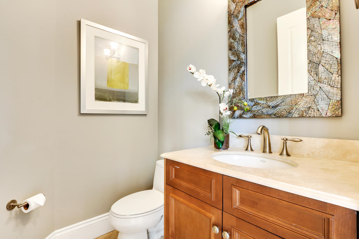 128 Tulip Tree Court Jupiter, FL 33458 - Photo 28 of 35 a bathroom with a granite countertop sink and a toilet