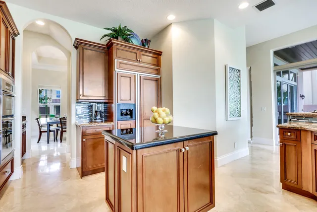 a kitchen with stainless steel appliances granite countertop a refrigerator and a stove