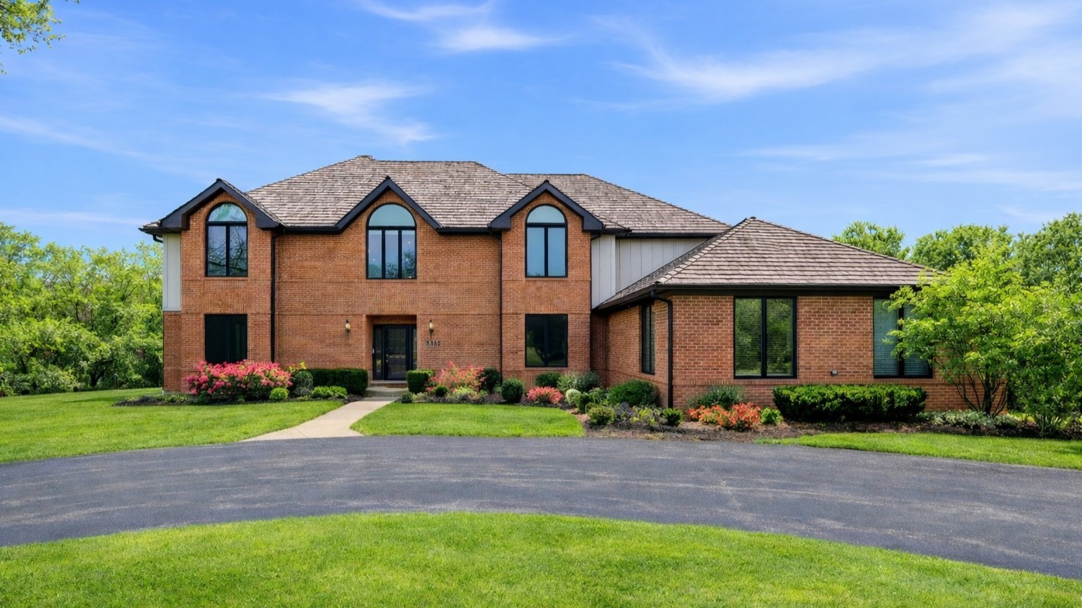 a front view of house with yard and green space