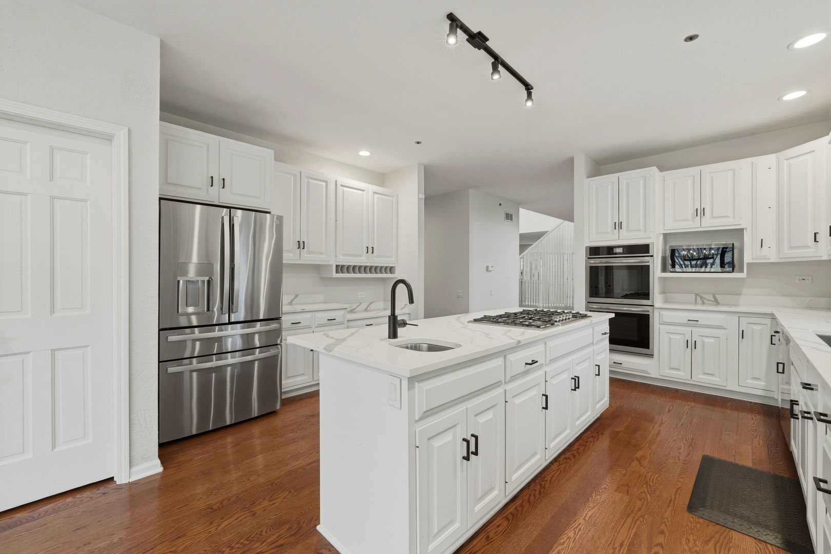 5212 Briarcrest Lane Long Grove, IL 60047 - Photo 11 of 50 a kitchen with kitchen island white cabinets and stainless steel appliances