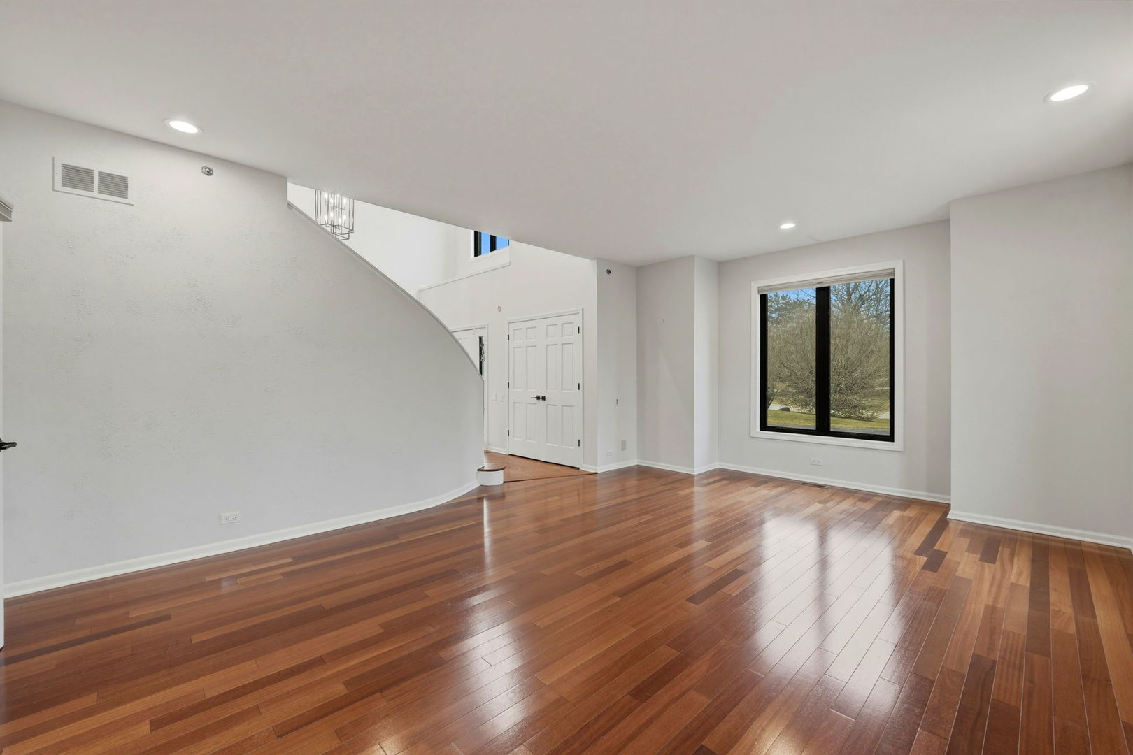 5212 Briarcrest Lane Long Grove, IL 60047 - Photo 20 of 50 a view of an empty room with wooden floor and a window