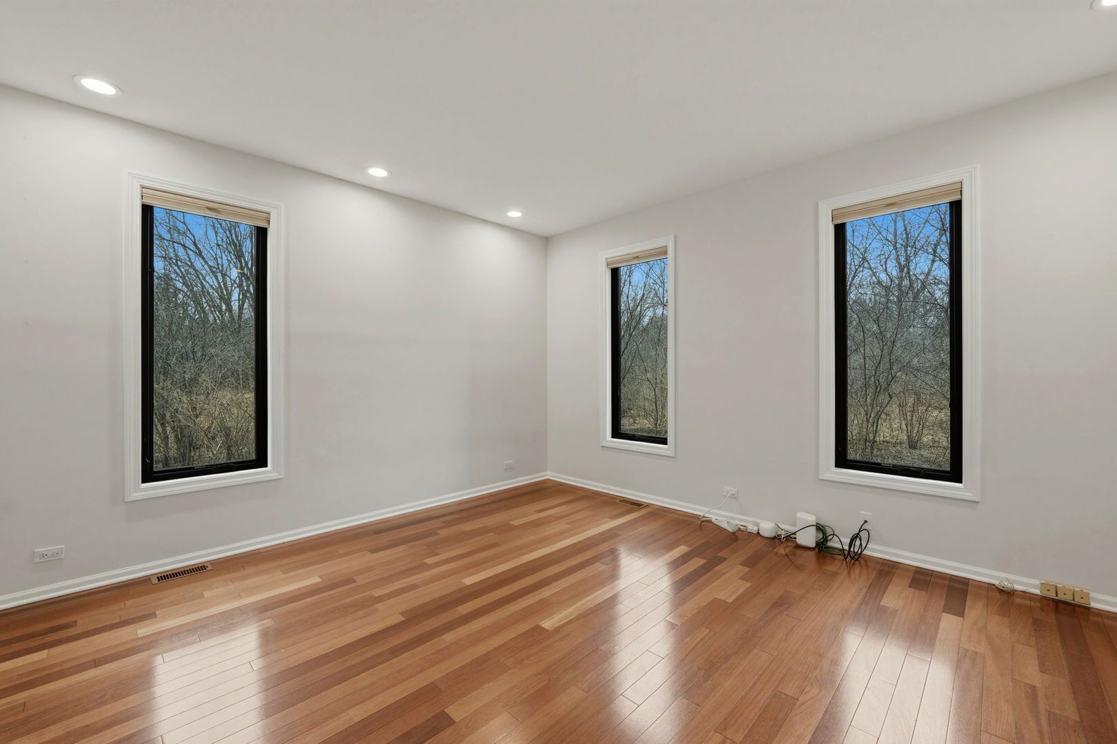 5212 Briarcrest Lane Long Grove, IL 60047 - Photo 21 of 50 a view of an empty room with window and wooden floor
