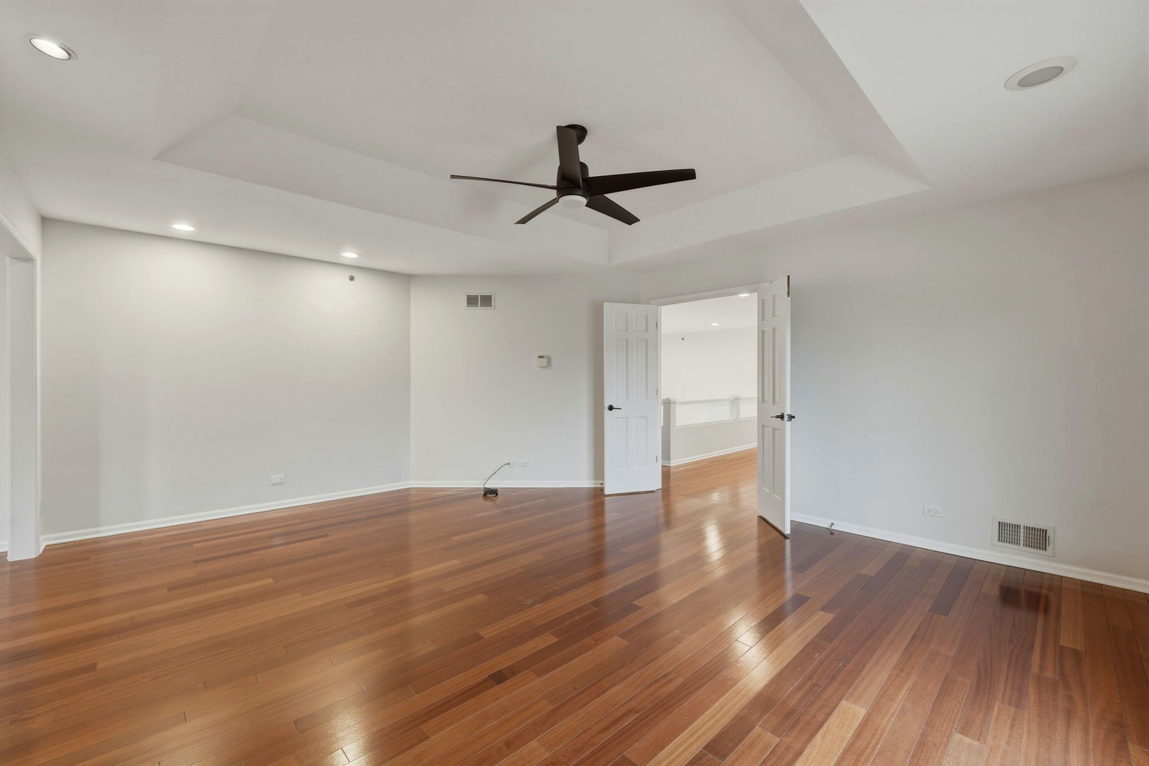 5212 Briarcrest Lane Long Grove, IL 60047 - Photo 25 of 50 a view of an empty room with wooden floor and a ceiling fan