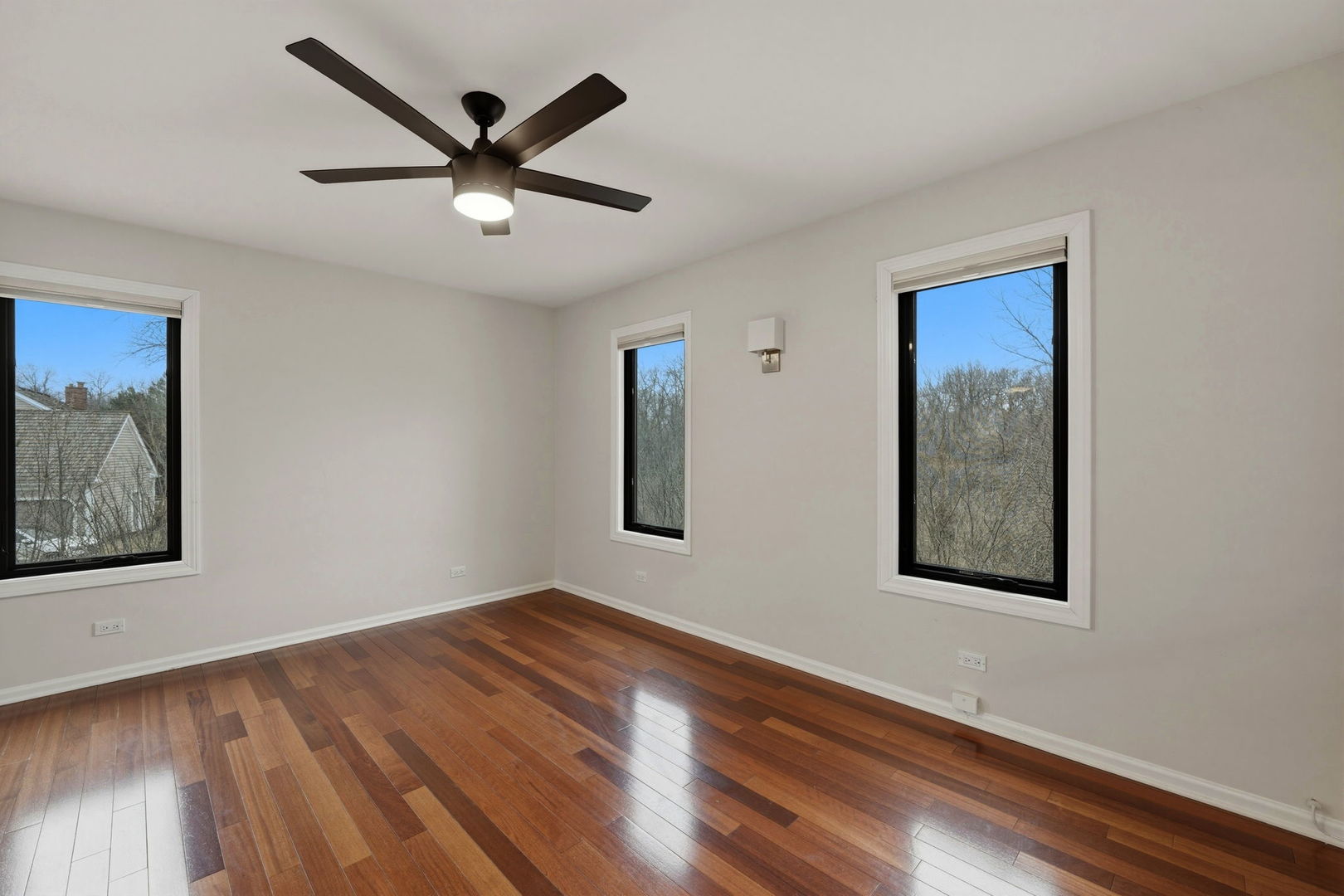 5212 Briarcrest Lane Long Grove, IL 60047 - Photo 29 of 50 a view of an empty room with wooden floor and a ceiling fan