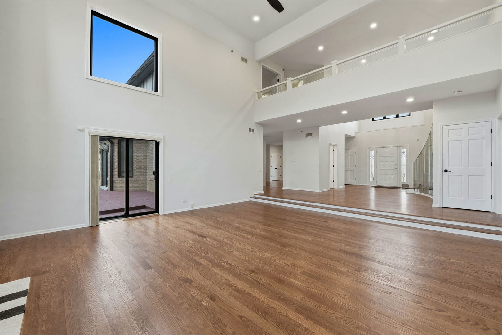 5212 Briarcrest Lane Long Grove, IL 60047 - Photo 7 of 50 an empty room with wooden floor and windows