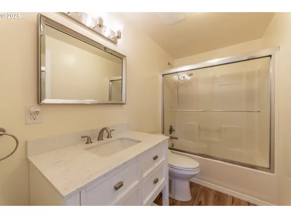 a bedroom with a bed mirror and window