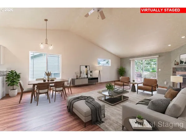 a living room with furniture a window and wooden floor