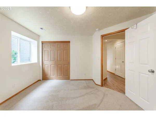 a bedroom with a bed and a large window