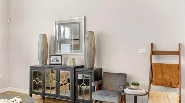 a view of a room with furniture and wooden floor