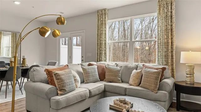 a living room with furniture and large windows