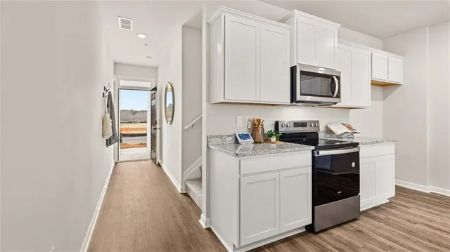 a view of a kitchen with electric appliances