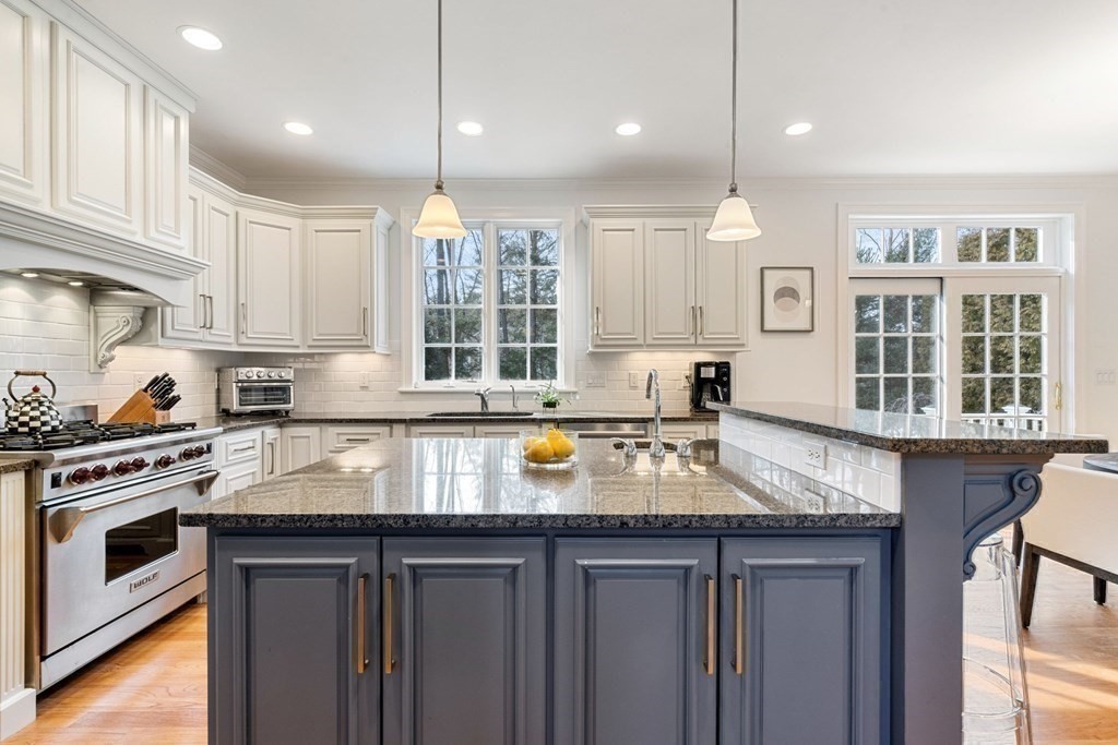 51 Baker Place Newton, MA 02462 - Photo 11 of 38 a kitchen with stainless steel appliances granite countertop a stove sink and cabinets