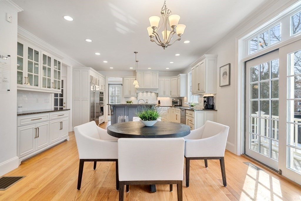 51 Baker Place Newton, MA 02462 - Photo 13 of 38 a kitchen with a dining table chairs and refrigerator