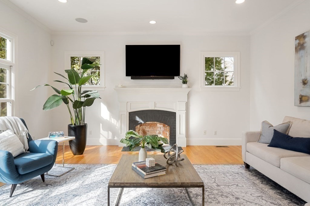 51 Baker Place Newton, MA 02462 - Photo 16 of 38 a living room with furniture a fireplace and a flat screen tv