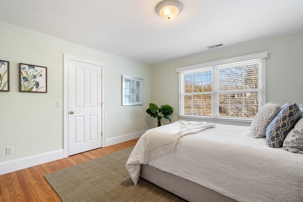 51 Baker Place Newton, MA 02462 - Photo 23 of 38 a large bed sitting in a bedroom next to a window