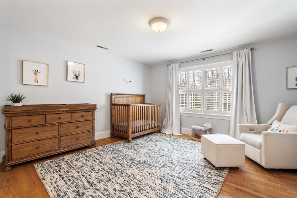 51 Baker Place Newton, MA 02462 - Photo 28 of 38 a bedroom with a bed and wooden floor