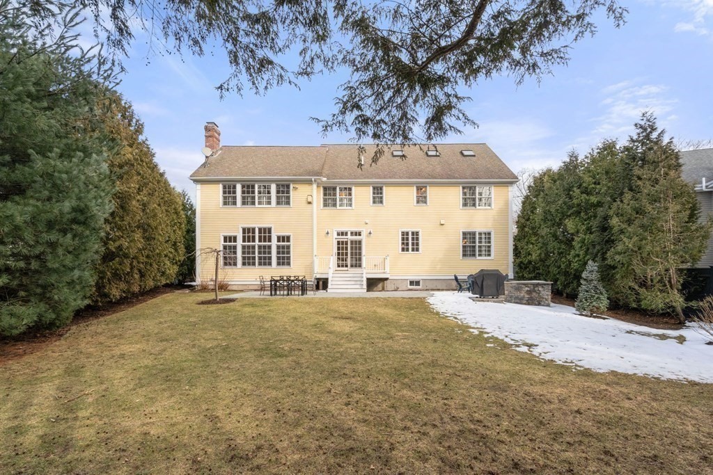 51 Baker Place Newton, MA 02462 - Photo 34 of 38 a view of a white house with a big yard and large trees