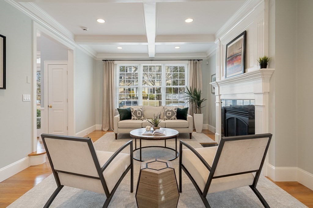51 Baker Place Newton, MA 02462 - Photo 8 of 38 a dining room with furniture and a fireplace