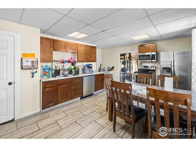 a kitchen that has a table and chairs in it