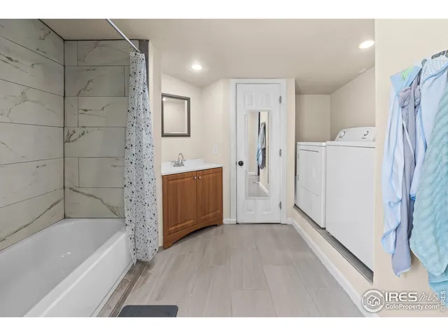 a bathroom with a bathtub a toilet a sink and a shower