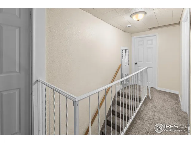 a view of a hallway with stairs