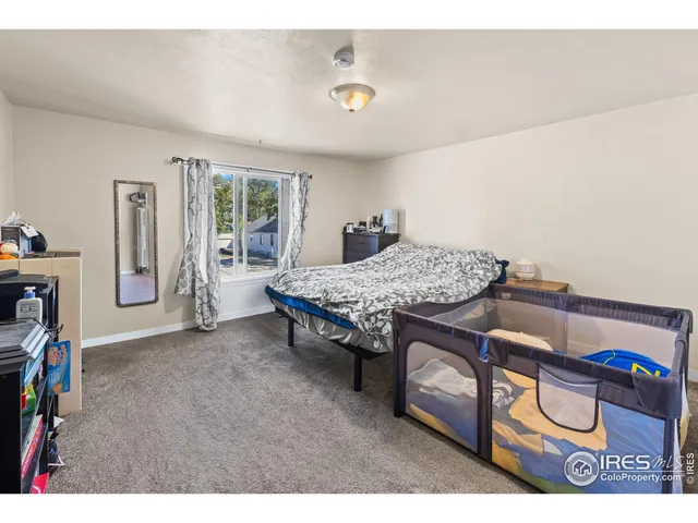 a bedroom with furniture and a window