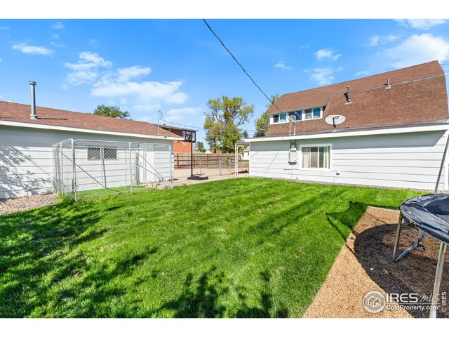 a view of a chairs and table in front of a house