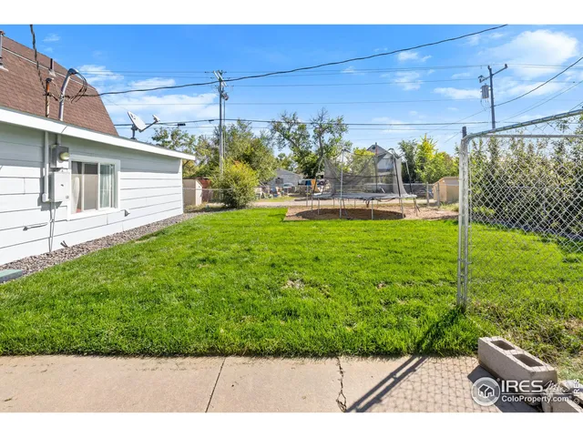 a view of a backyard with plants and patio
