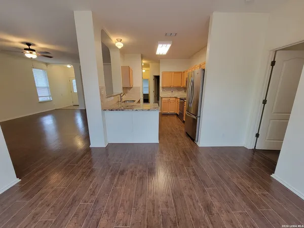 a view of a kitchen from a hallway
