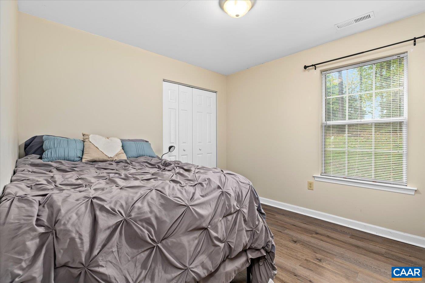1003 West Daffodil Road Ruckersville, VA 22968 - Photo 13 of 26 a bedroom with a bed and wooden floor