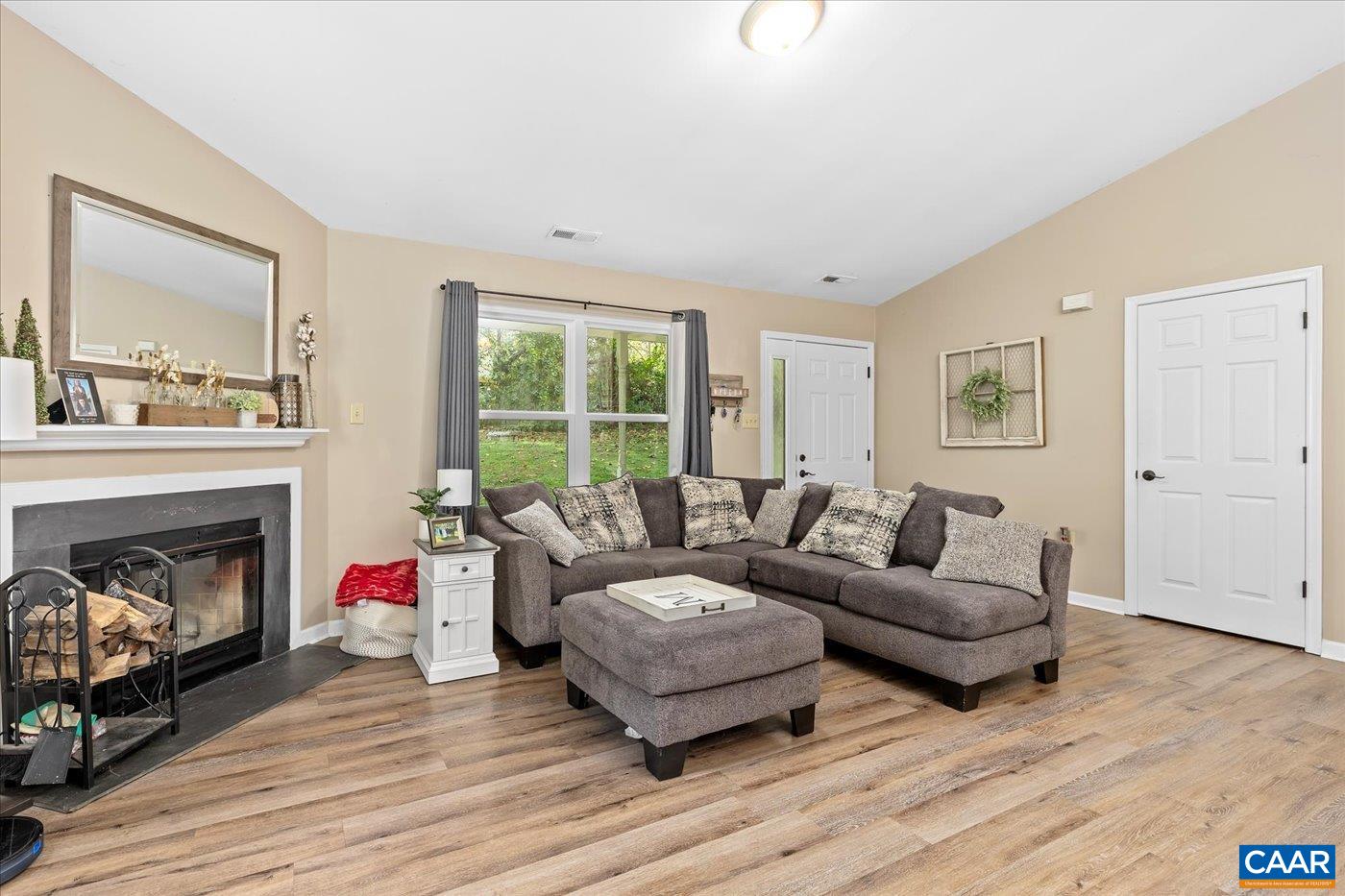 1003 West Daffodil Road Ruckersville, VA 22968 - Photo 5 of 26 a living room with furniture and a fireplace