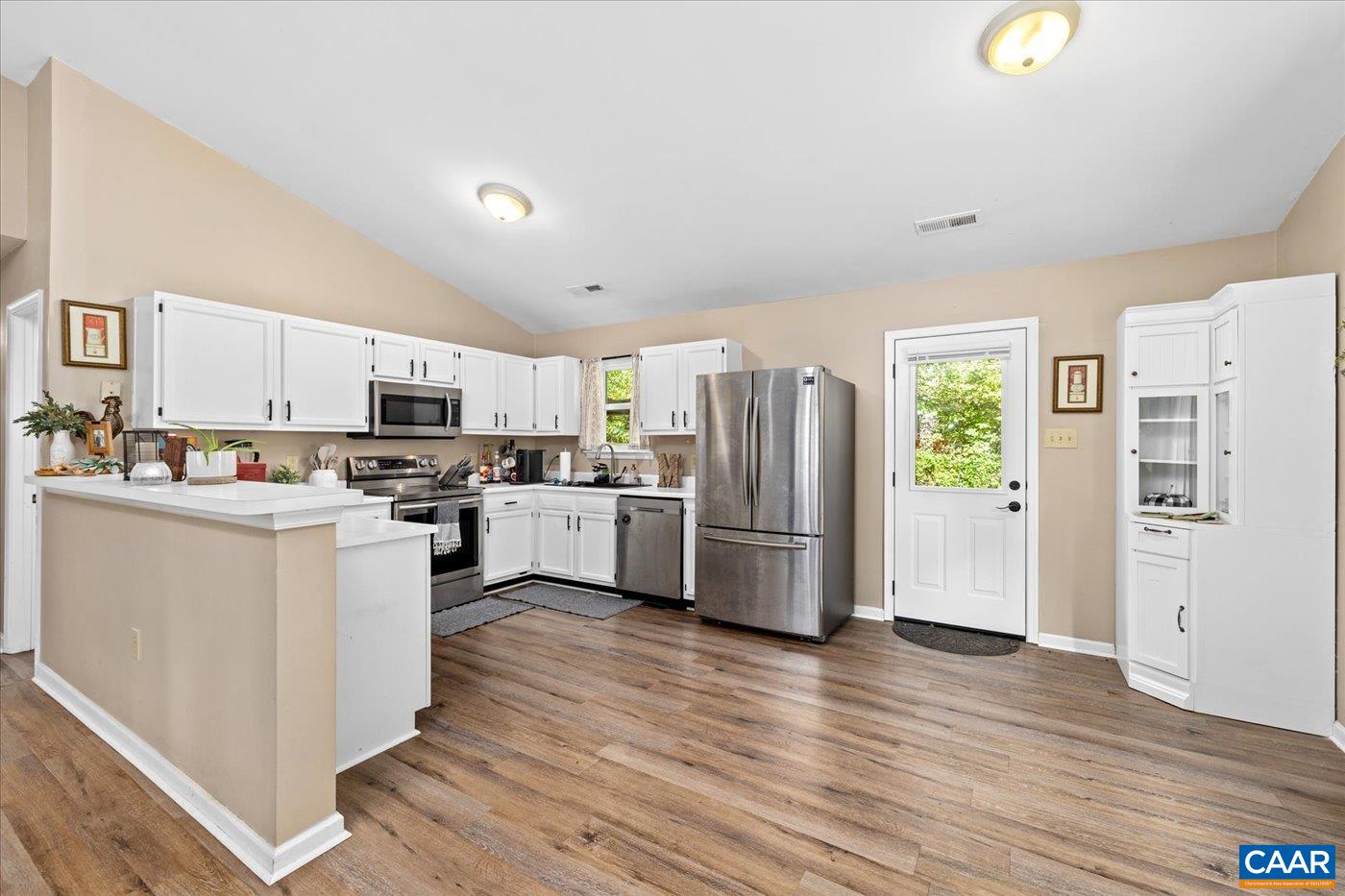 1003 West Daffodil Road Ruckersville, VA 22968 - Photo 7 of 26 a kitchen with refrigerator a microwave and cabinets