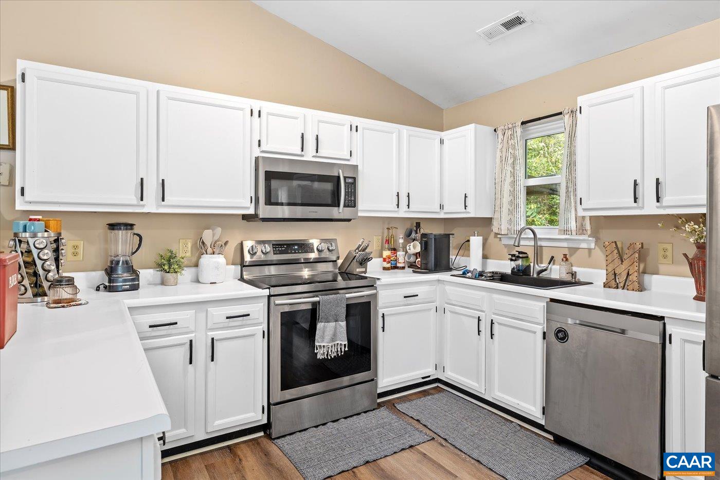 1003 West Daffodil Road Ruckersville, VA 22968 - Photo 8 of 26 a kitchen with cabinets stainless steel appliances a sink and a window