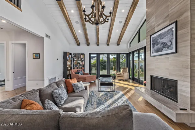 a living room with furniture and large windows