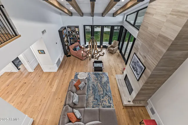 a kitchen with stainless steel appliances kitchen island granite countertop a stove a sink and white cabinets with wooden floor