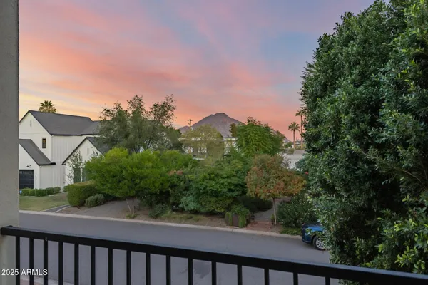 a view of a living room with furniture and wooden floor