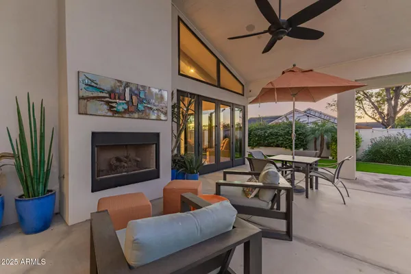 a living room with furniture a chandelier and a fireplace