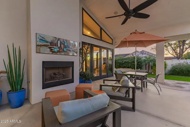 a living room with furniture a chandelier and a fireplace