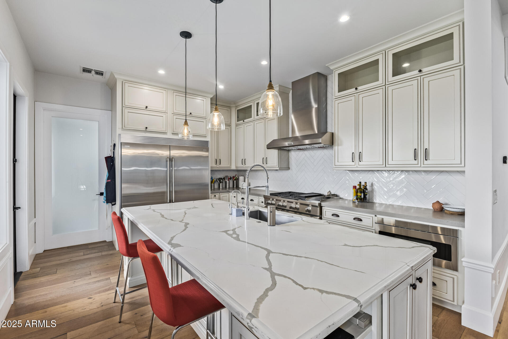 3810 East Campbell Avenue Phoenix, AZ 85018 - Photo 6 of 41 a kitchen with stainless steel appliances granite countertop a sink a stove a refrigerator and island with wooden floor