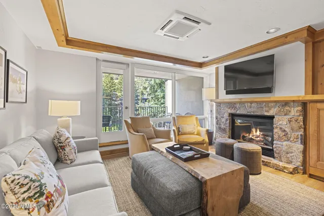 a dining room with furniture a fireplace and wooden floor