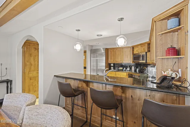 a bathroom with a sink vanity mirror and toilet