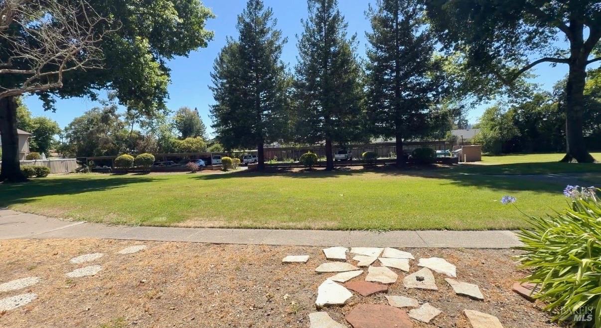 303 Algiers Court Santa Rosa, CA 95409 - Photo 25 of 27 Mature trees, sprawling lawn, and walking path right outside your gate!