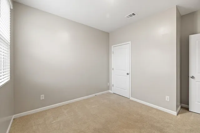 a view of an empty room and closet area