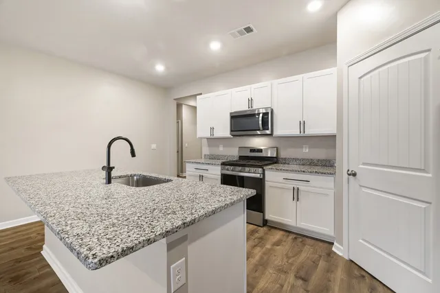 a kitchen with sink and cabinets