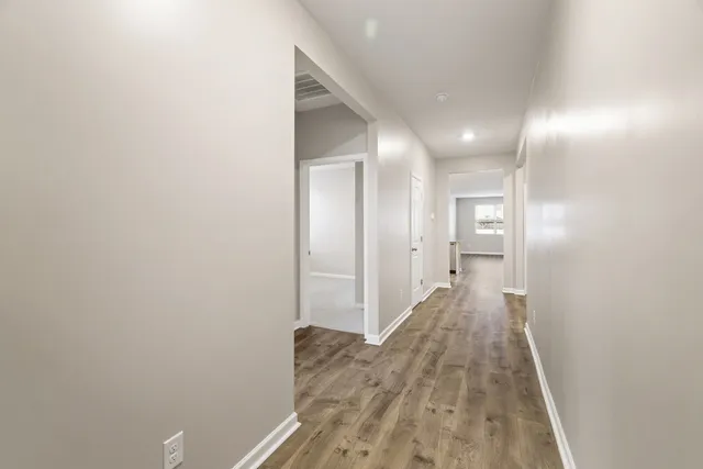 a view of hallway with wooden floor