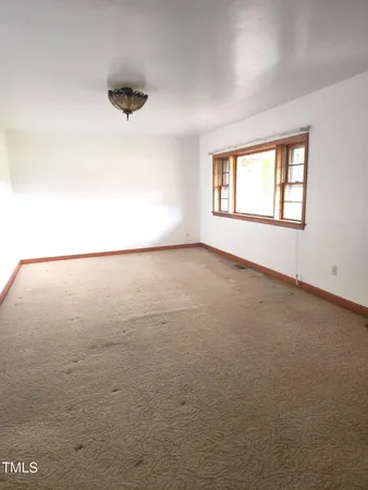 an empty room with a empty space and windows