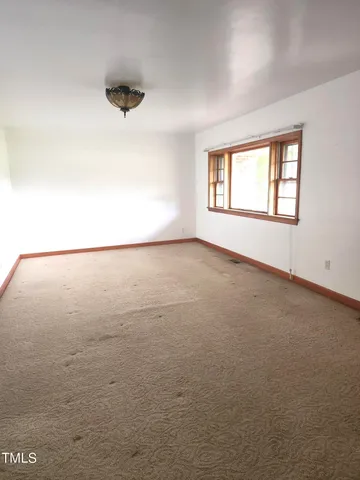 an empty room with a empty space and windows