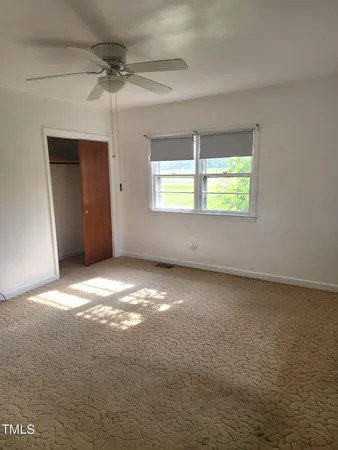 a view of a house with large trees